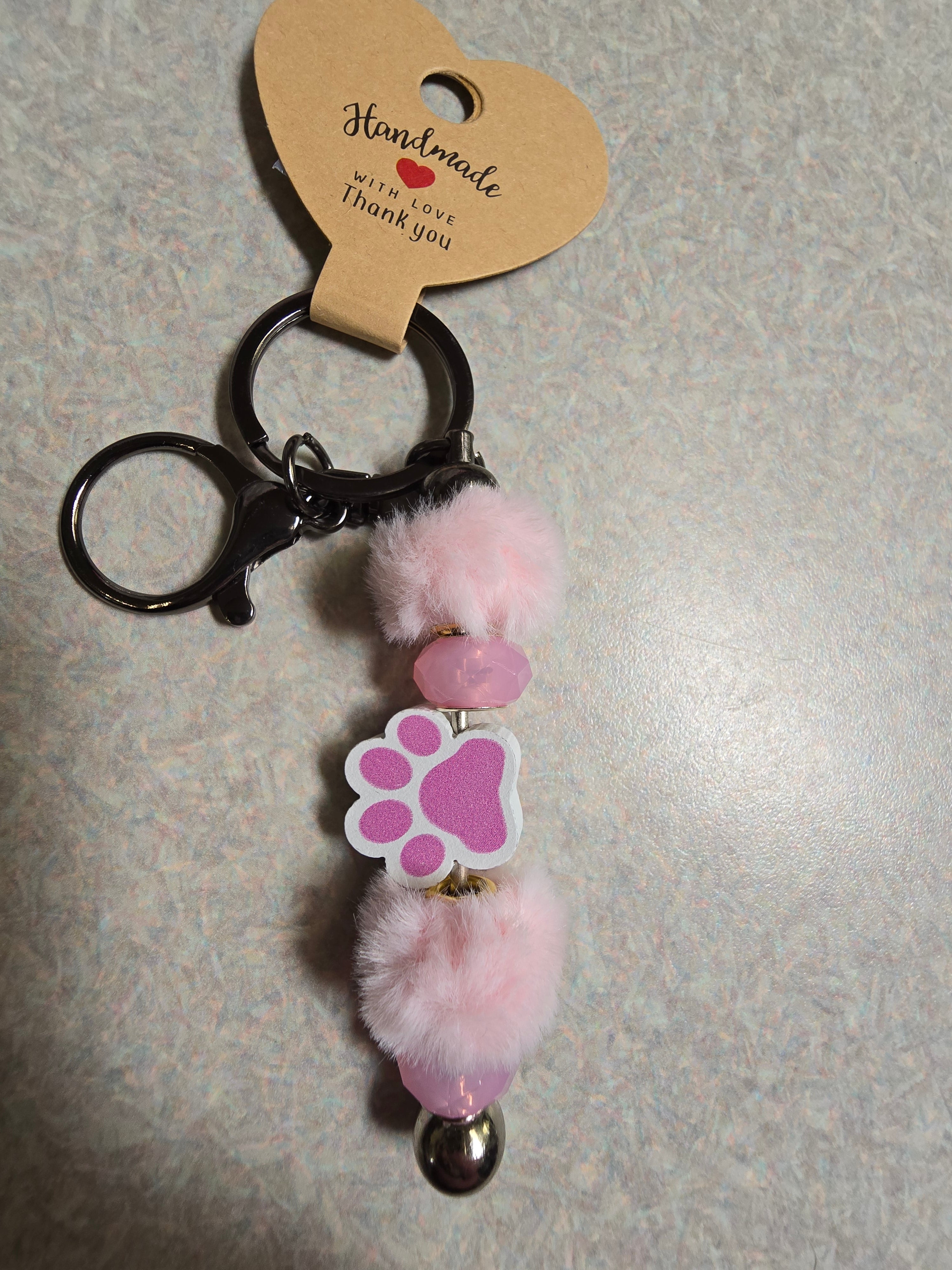 Pink fuzzy pawprint keychain